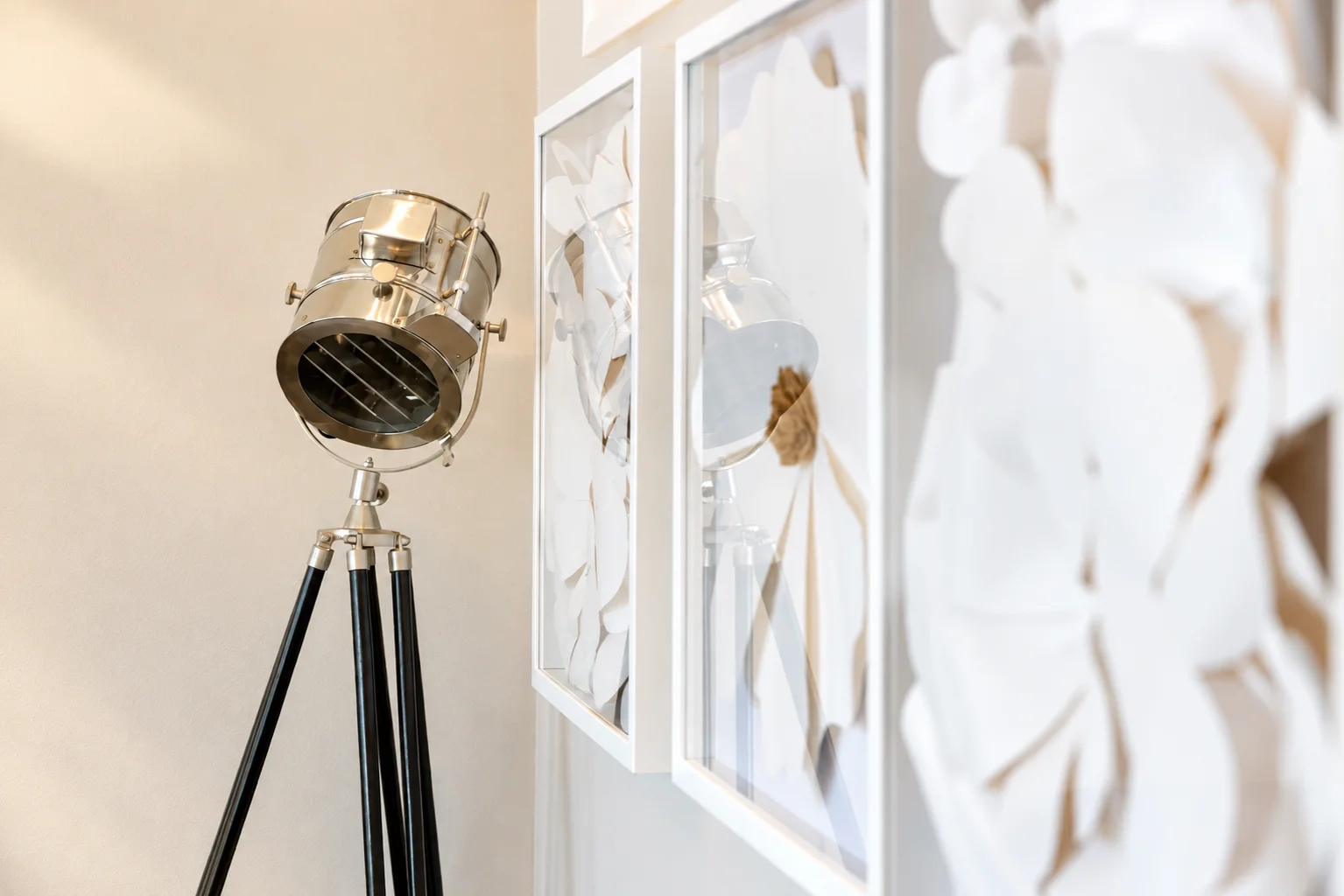 Bright reception area with a studio spotlight lamp and framed art